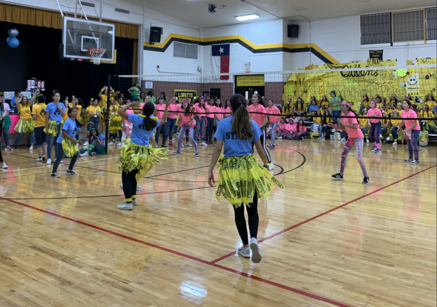 A day of colors and unity. LAA staff pictured playing against freshmen. Senior wall on the background displaying their school spirit, besides the senior dancing.