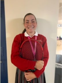 A racket in her hand as always. Jayne Novak poses with a racket and a huge smile. Her smile shows her vivacious personality.  Photo courtesy of the author.