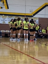Varsity volleyball team pictured doing a team talk. They hug one another, showing their support. Photo courtesy of the author.
