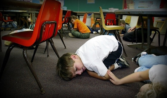 Kindergarten students lying on the floor and hiding behind desks during a lockdown drill in Hawaii in 2003. School lockdown drills have been commonplace since the 1999 Columbine shooting; however, just because a practice is common doesn’t mean it shouldn’t be questioned. Photo courtesy of Getty Images.