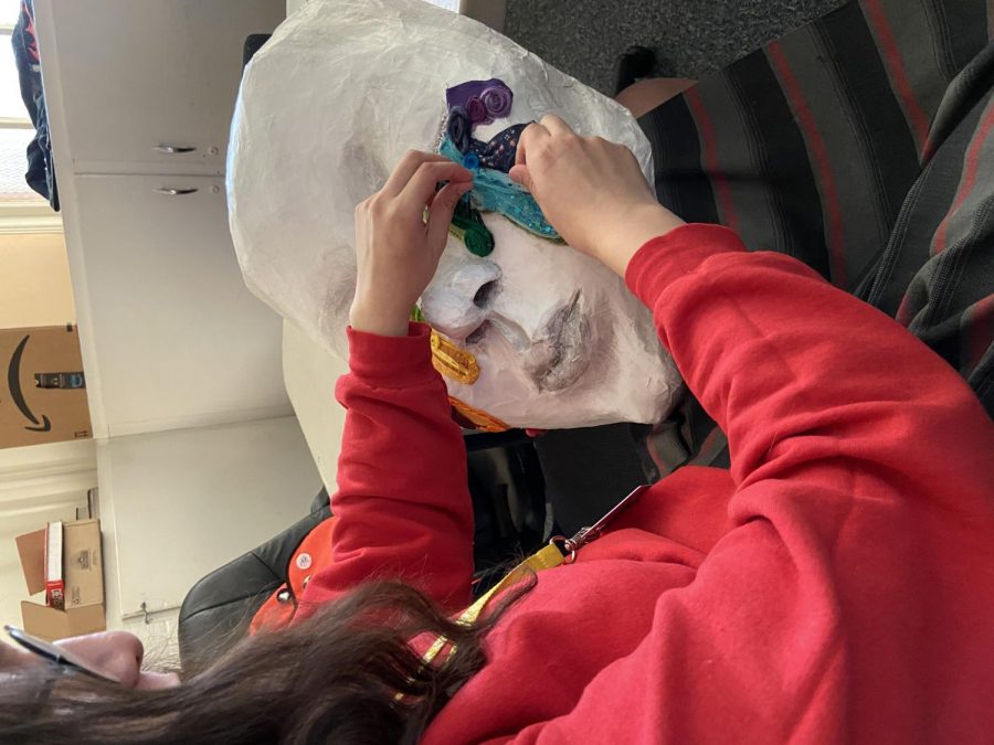 Catherine Carreon, vice president of National Art Honor Society, adds finishing touches to her art piece. Her piece touches on the oppression of the LGBTQ+ community.
Photo courtesy of the author.
