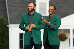 Dustin Johnson receiving his first Green Jacket from former Master titleholder, Tiger Woods. Johnson set a new course record while clutching his win. 
