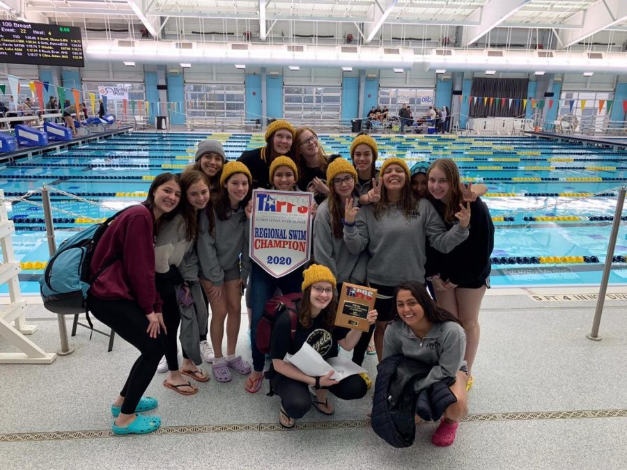 Loretto%E2%80%99s+swim+team+were+Regional+Champions+in+2020.+The+team+poses+for+a+photo+with+their+plaque+and+banner.+%0A