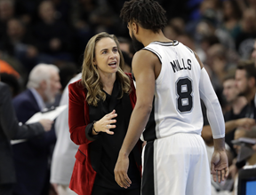 Becky Hammon talking to Spurs player Patty Mills. Becky Hammon was the first woman to be acting head coach in a regular-season NBA game.
