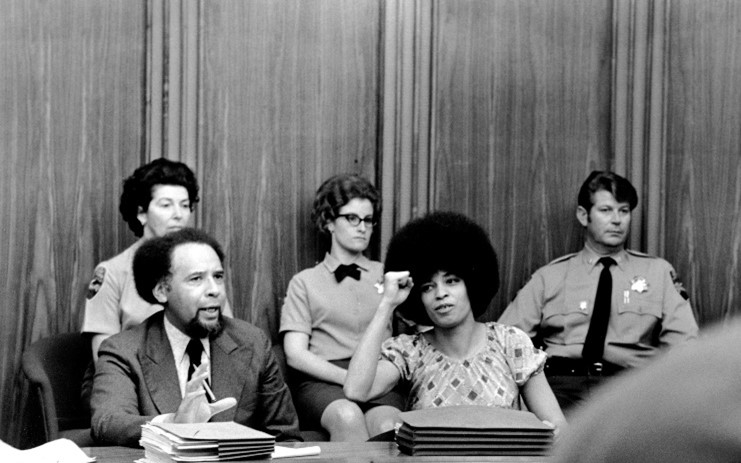 Davis raises the fist of power during a courtroom hearing in 1971. She is a fierce progressive activist who continues to fight for humanitarian issues to this day. 