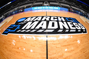 The highly regarded March madness logo on the center of the court that many tournament games will take place on. This year, the tournament will only take place in Indianapolis, Indiana within a bubble. 
