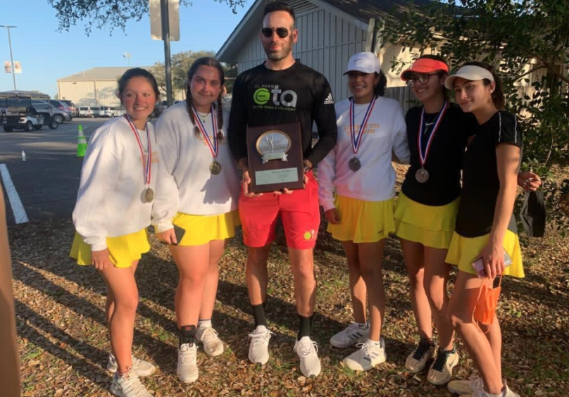 The+girls+smile+for+a+picture+with+their+coach+at+Regionals.+They+were+given+the+plaque+after+their+last+game+to+bring+back+to+Loretto+to+display%21+