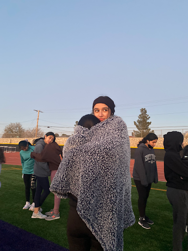 Loretto track runner, Monse Medina, taking a break in the cold weather preparing for her next run. Loretto Angels prepared for their new track season by building endurance for their first meet of the year. 
