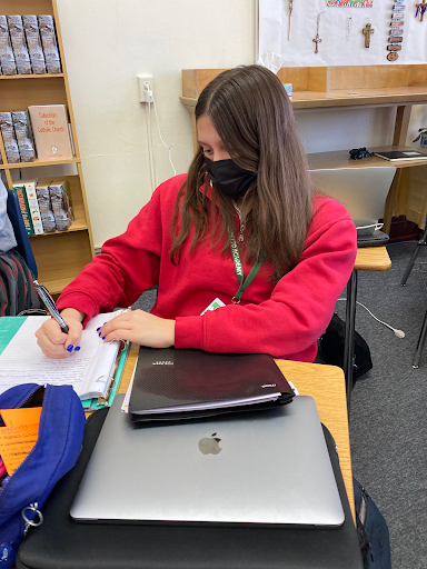 Junior, Catalina Martinez, practicing school safety guidelines while attending her classes. Loretto students follow  safety regulations to minimize the spread of Covid-19. 