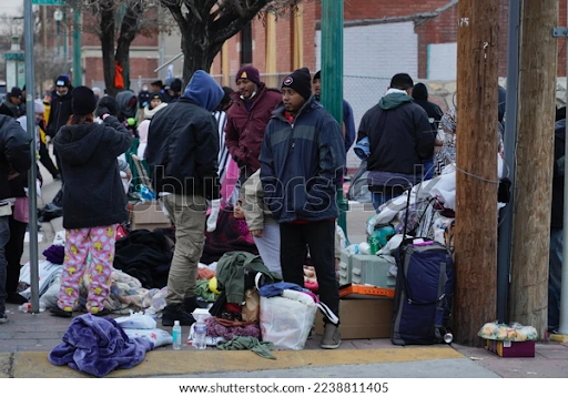 On Dec. 16, 2022, migrants gather in downtown El Paso, Texas. Many shelters were overcrowded, forcing migrants to live on the streets. Photo courtesy of Shutterstock