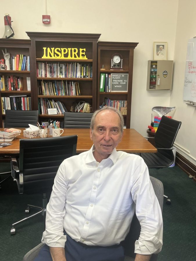 Loretto Academy’s high school principal, Mr. Homero Silva, sits in front of the “Inspire” sign in his office. Mr. Silva has made it a point to recognize the individuals who inspire the Loretto community. Photo courtesy of Orlyanka Tantchou 