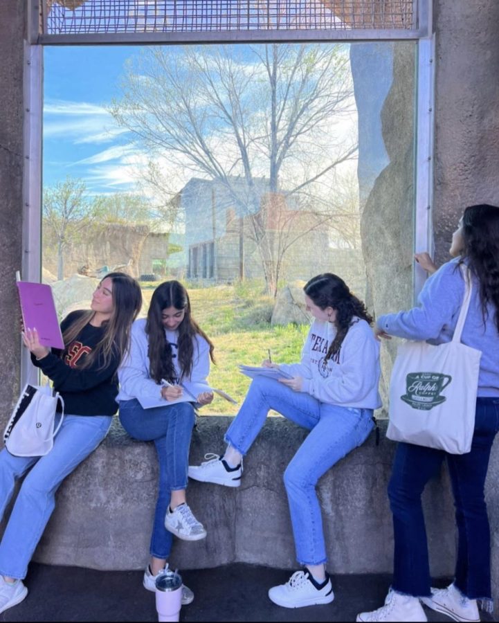 Students+sit+around+the+animal+exhibits+and+write+down+adjectives+for+their+poems.+The+girls+were+allowed+to+wear+jeans+and+college+sweatshirts+of+their+choice.+Photo+courtesy+of+Carolina+Fernandez
