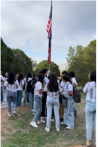  Junior class of 2025 lowers United States flag to half-staff in accordance with the national day of remembrance. Photo courtesy of Teresa Franco


