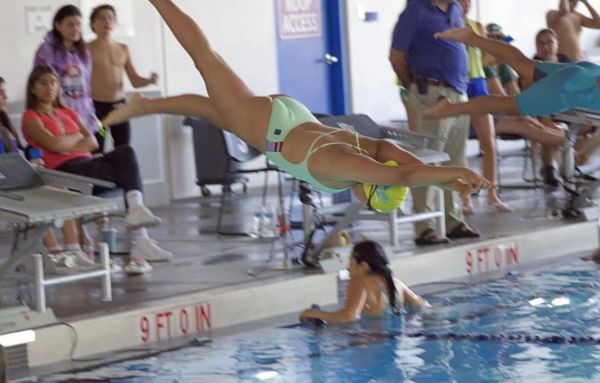 Sofia plunging into pool during swim meet. 
Photograph courtesy of Sofia Olvera.
