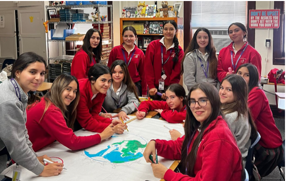 Sophomores in Mrs. Kimpell’s homeroom collaborating to make an “Action Plan” poster to help the environment. The creation of the posters being one of the main events conducted throughout Laudato Si’ Day. Photo courtesy of Julianna Gonzalez.
