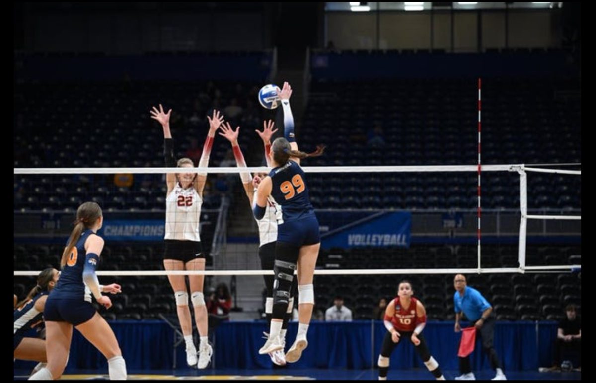 Four players ready to spike the volleyball. UTEP Minders and Oklahoma Sooners playing against each other in the NCAA tournament 2024 season.