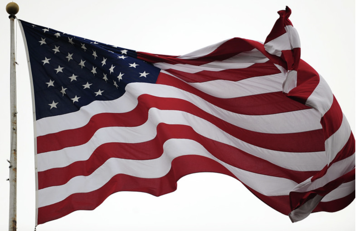 American Flag waving in the wind. In a time of uncertainty, the flag unites America as one people, no matter any differences.  Photo courtesy of flickr.
