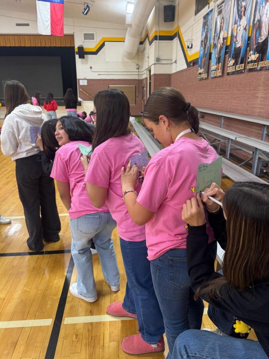 Freshmen participating in bonding activity by drawing on each others' back. Drawings were put up later
on the retreat. Photo courtesy of Camila Martinez.