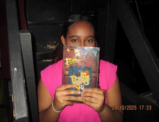 Isabelle Labrado holding up the Puffs playbill shortly before the play begins. Photo courtesy of Paula Geedey.