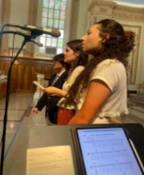 Andrea Alonzo, Ema Lucia Muniz, and Alex Quevedo singing “Loretto of the Plains” for the Alumni mass. Photo courtesy of Mr.Hernandez.