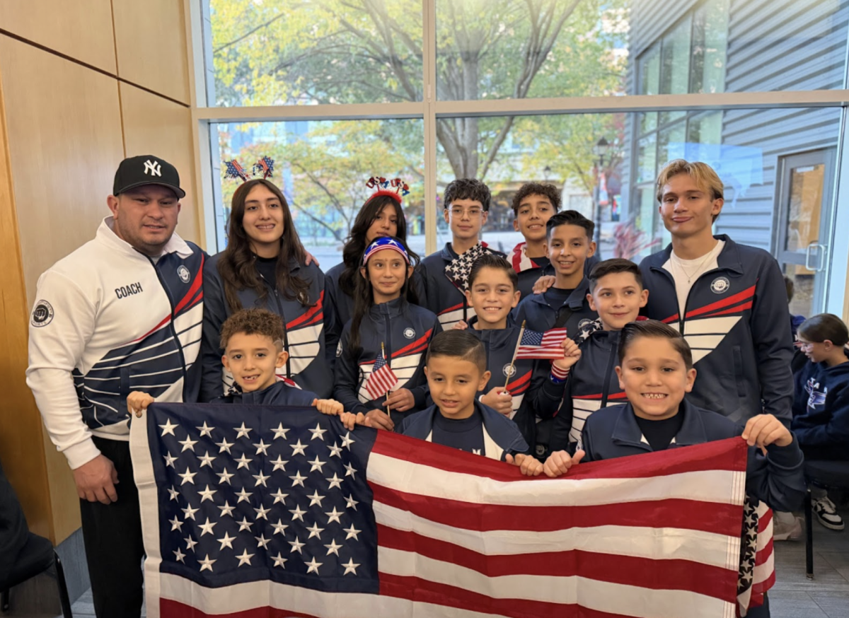 Yorely Hermosillo is located on the left hand side of the image, supporting her team at the karate world championship. She stands proudly with her team, embodying dedication and true passion for the sport. Photo courtesy of Yorely Hermosillo.