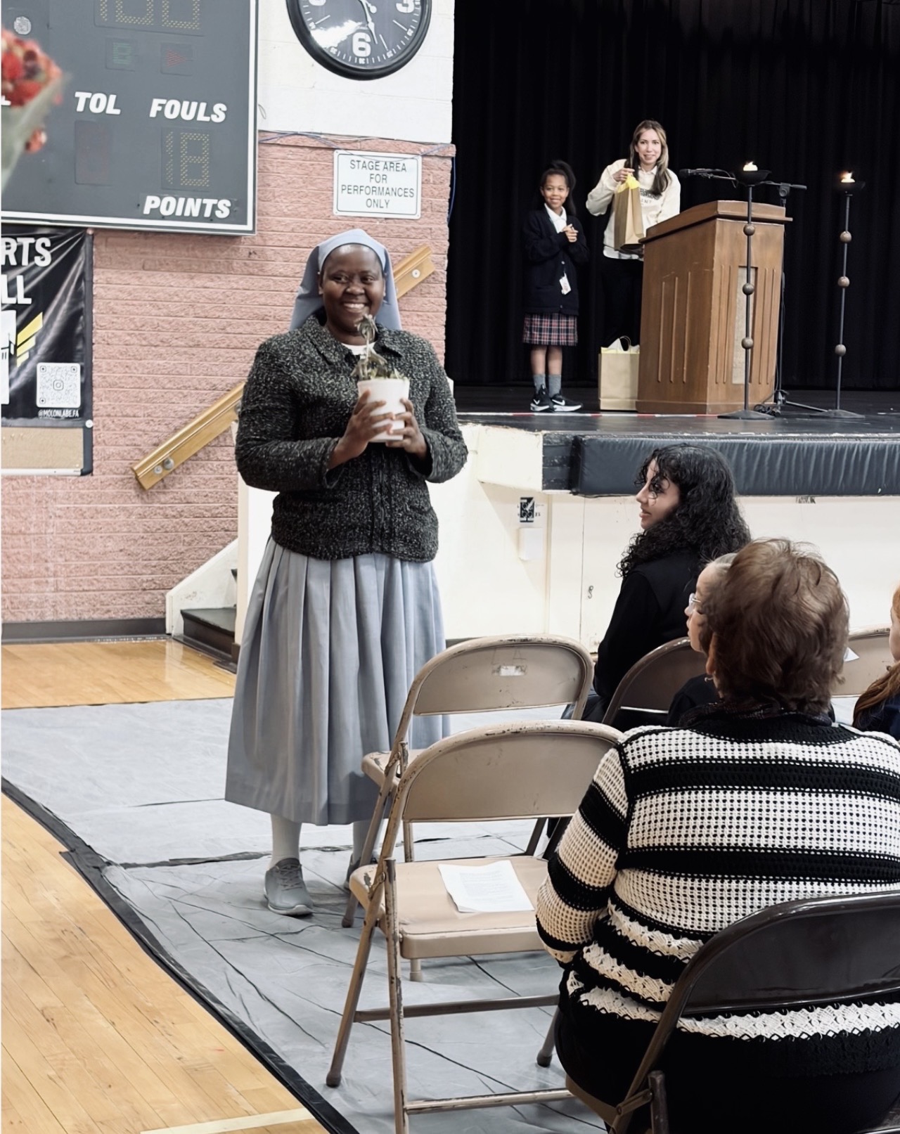 Sister Olive is pictured holding a plant that was given as a token of appreciation.	Her vocation is celebrated at Loretto Academy and her dedication to her faith. Photo courtesy of Viviana Liano.